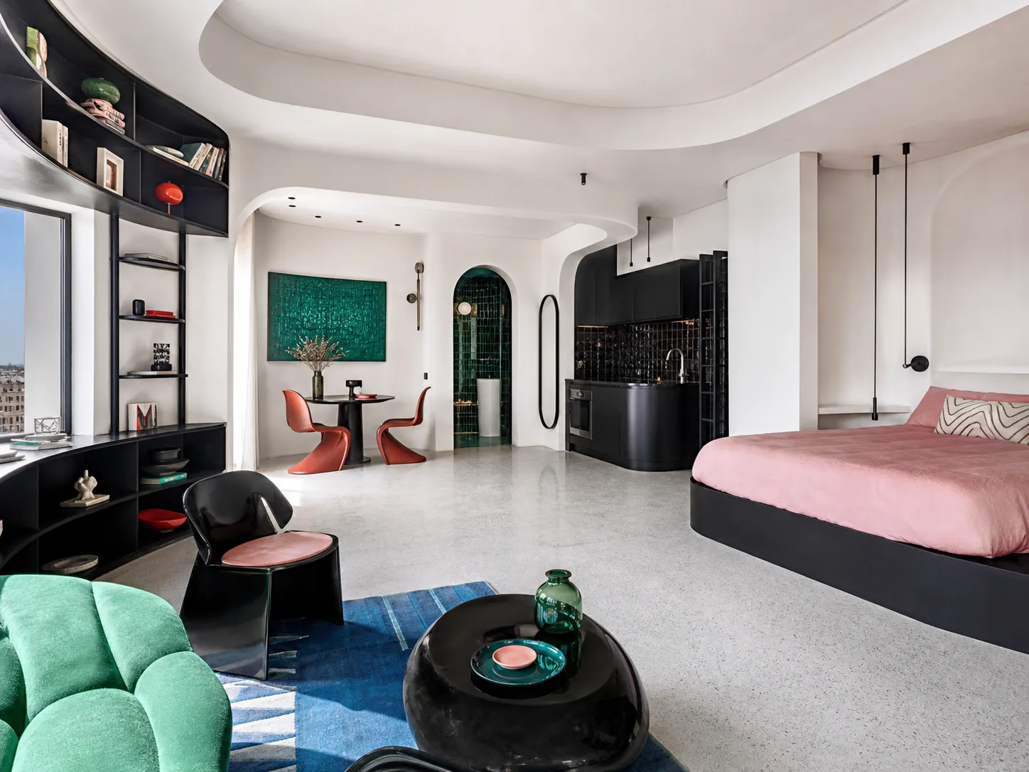 Apartment Ciel, appartement parisien rénové aux volumes courbes blancs, sol en terrazzo et cuisine noire avec vue sur les toits de Paris
